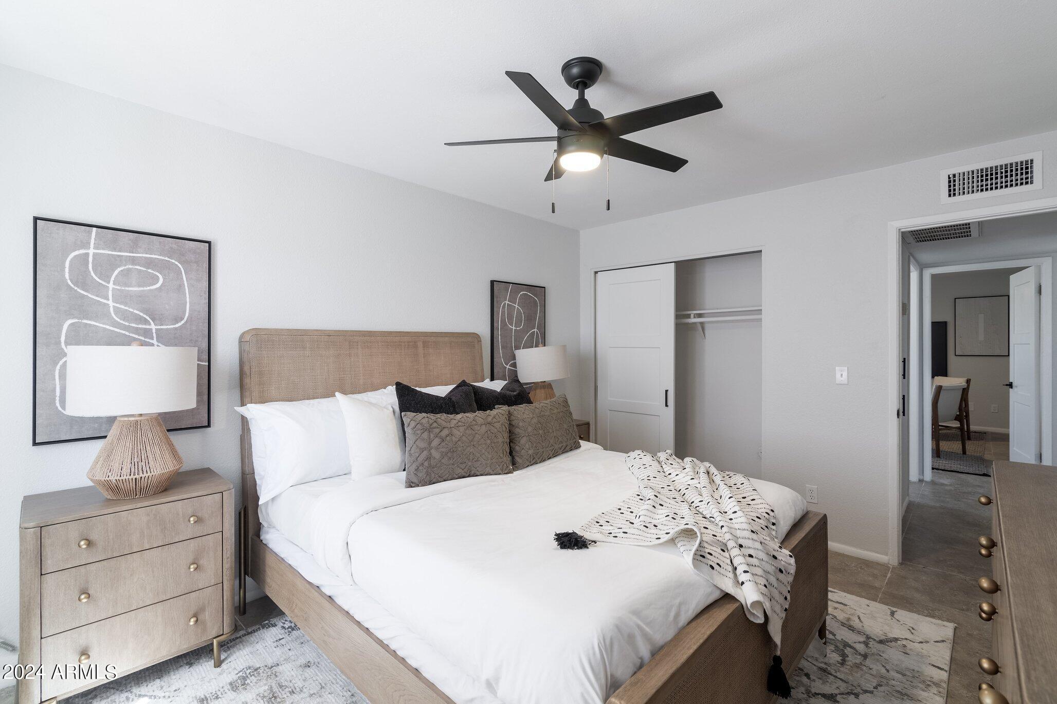 1615 North 51st Street, Unit 5 Phoenix, AZ 85008 - Photo 12 of 18 a bedroom with a large bed and a chandelier