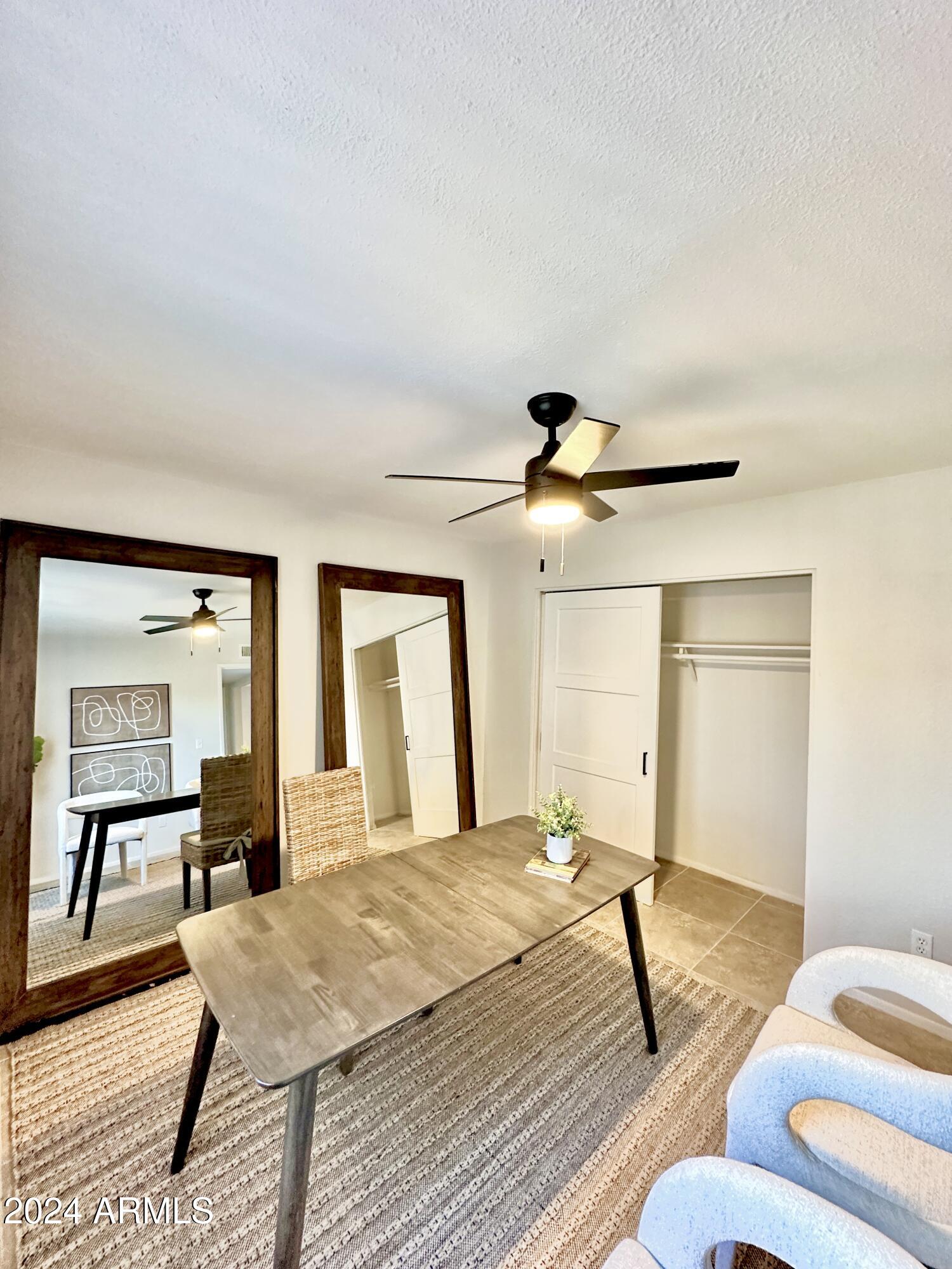 1615 North 51st Street, Unit 5 Phoenix, AZ 85008 - Photo 16 of 18 a bedroom with a bed and wooden floor