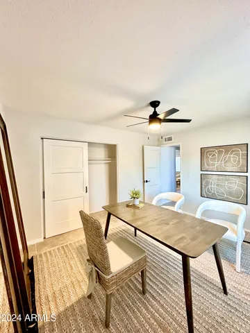 a view of a livingroom with furniture and a dining table