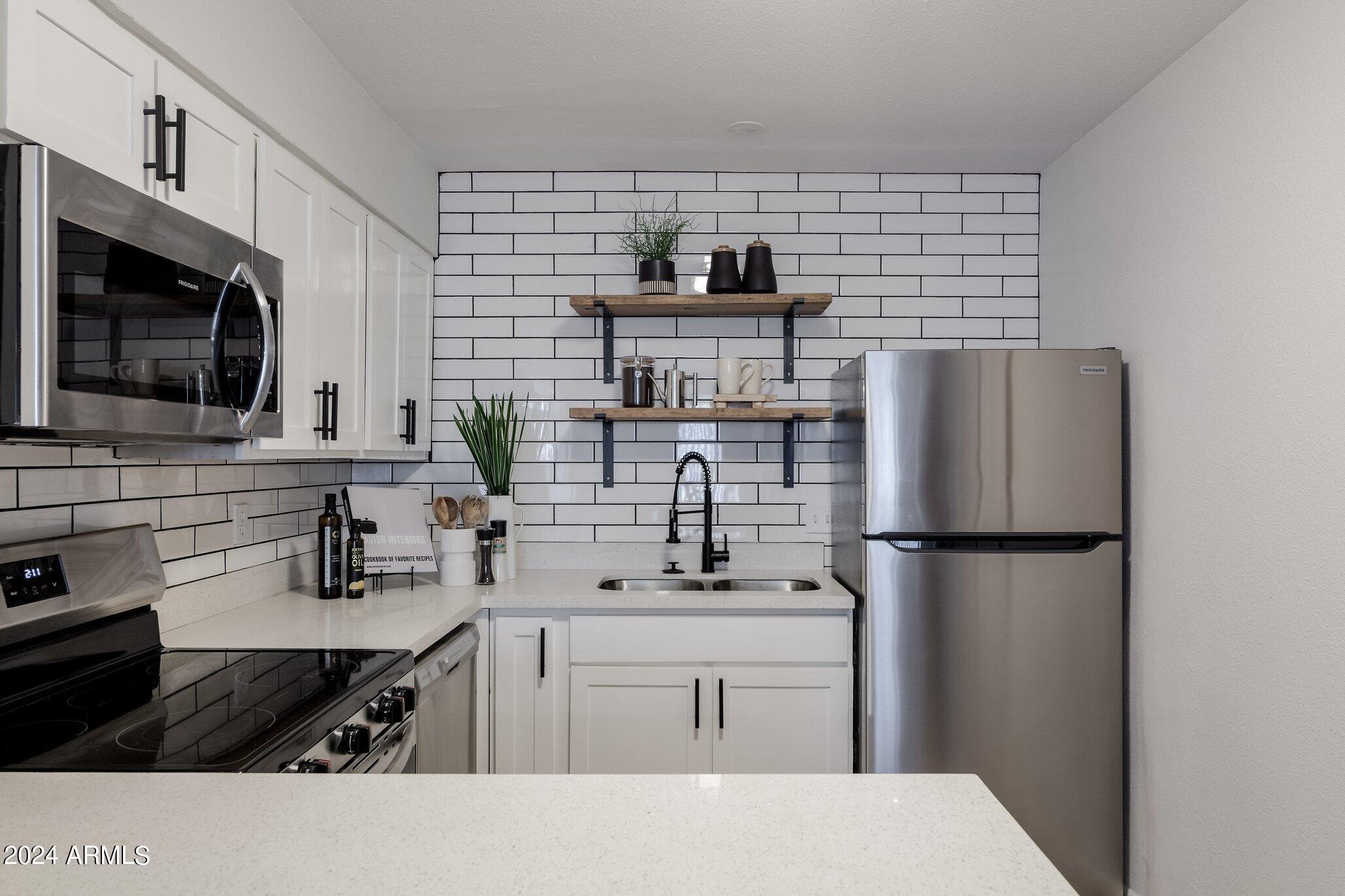 1615 North 51st Street, Unit 5 Phoenix, AZ 85008 - Photo 9 of 18 a kitchen with a refrigerator and a stove top oven