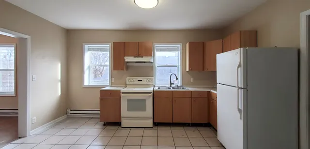 a kitchen with stainless steel appliances a refrigerator sink and cabinets