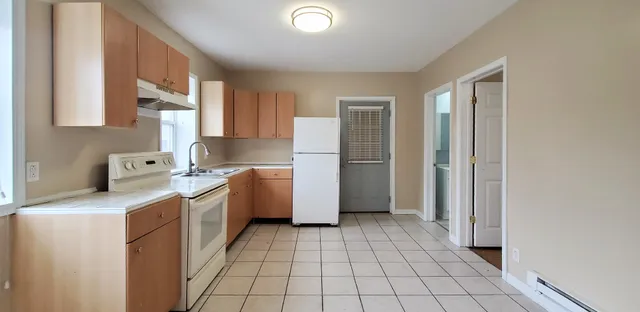 a kitchen with a stove a refrigerator and a sink