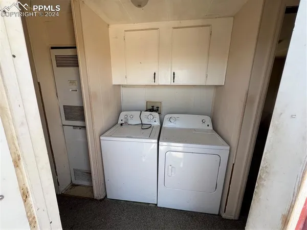 a view of a hallway with some storage and utility room