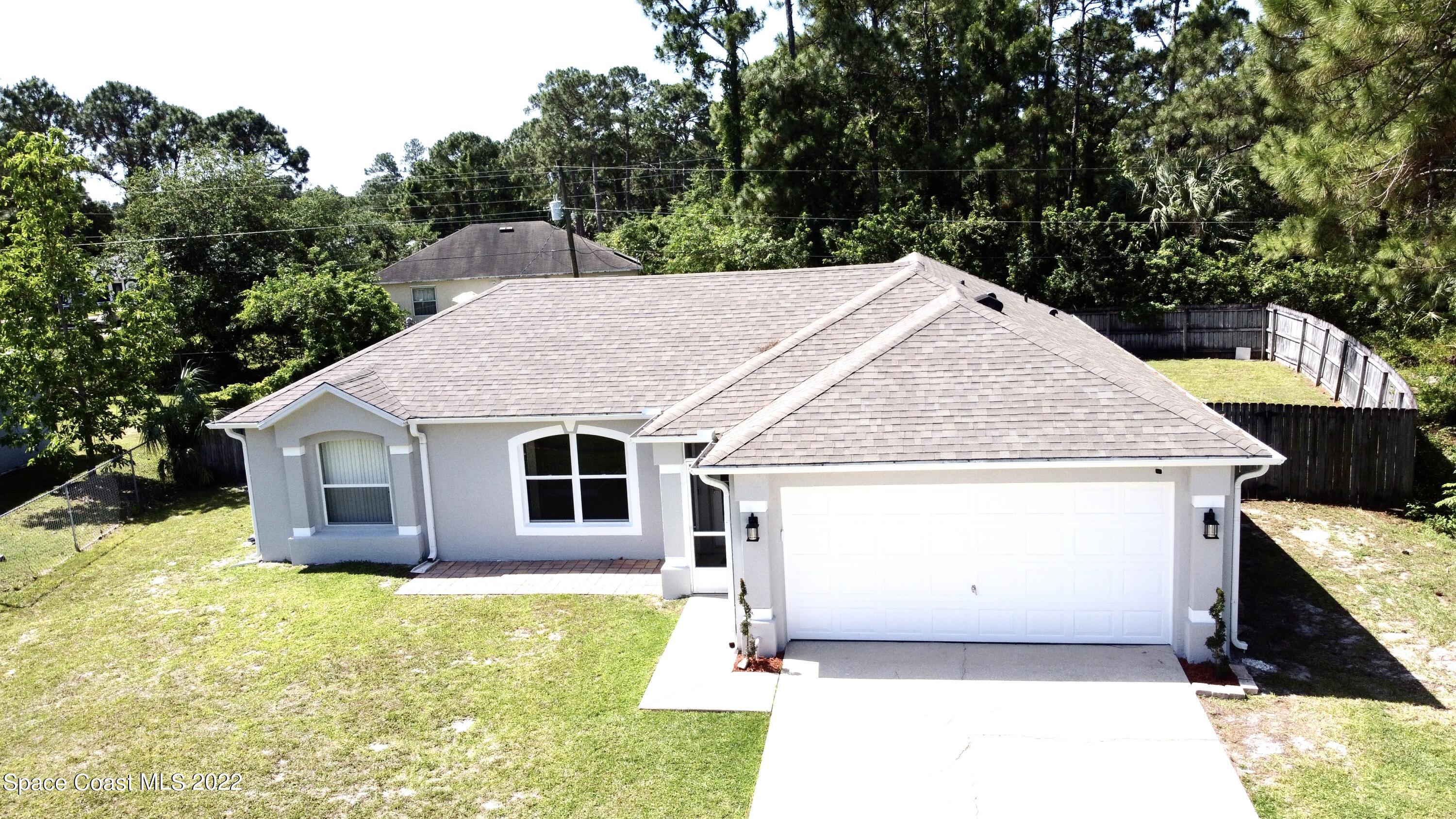 1290 Daton Road Southwest Palm Bay, FL 32908 - Photo 1 of 29 a house with trees in the background