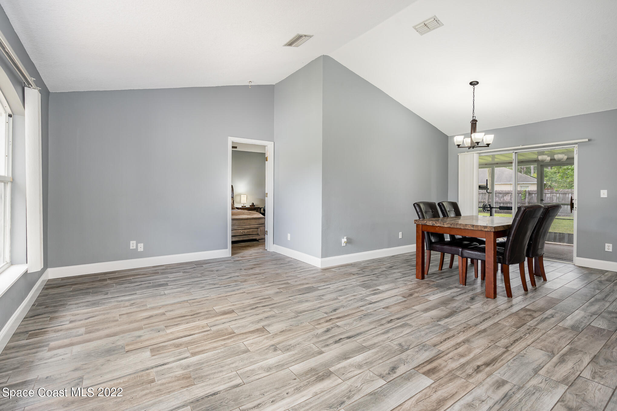 1290 Daton Road Southwest Palm Bay, FL 32908 - Photo 12 of 29 a view of a dining room with furniture window and wooden floor