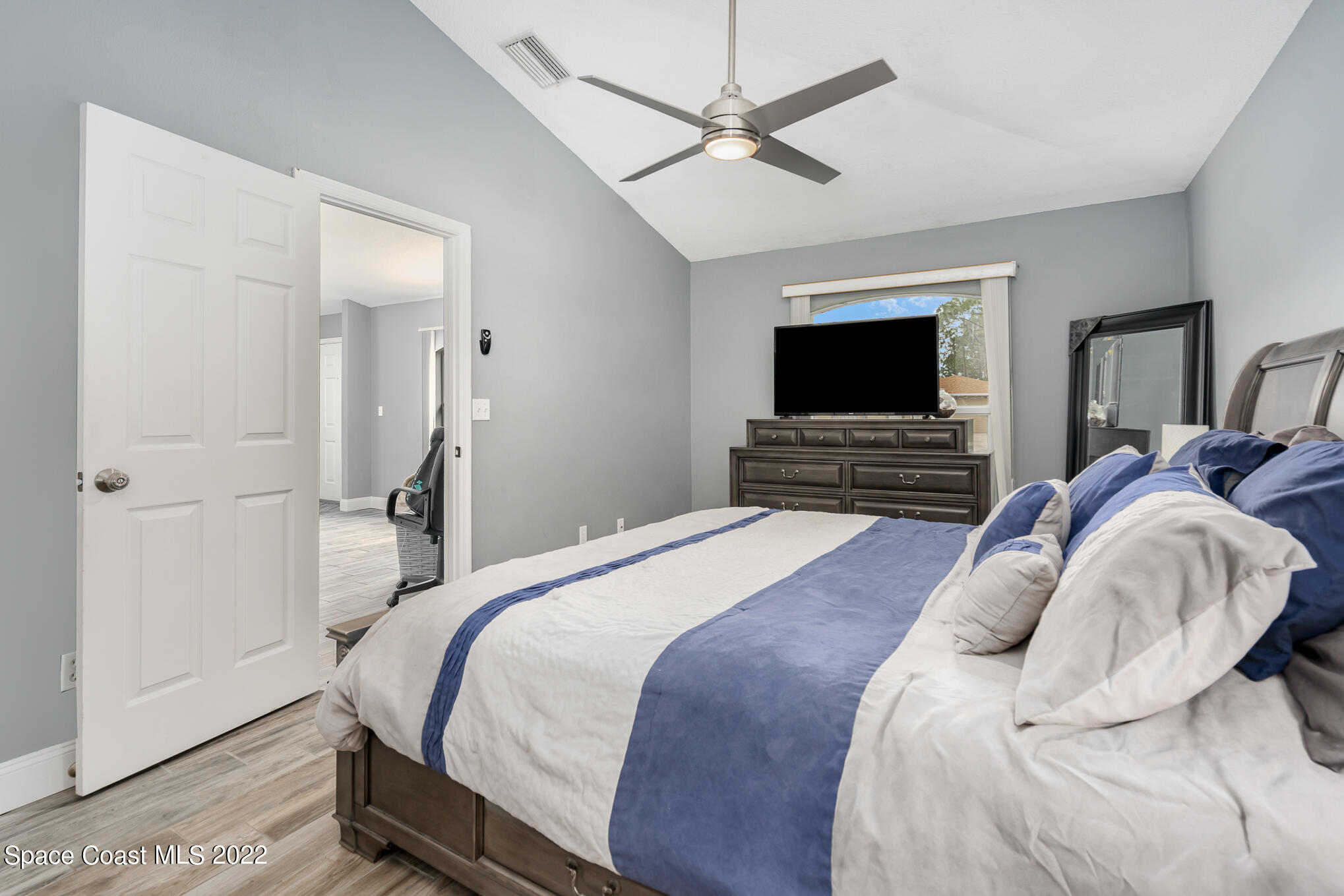 1290 Daton Road Southwest Palm Bay, FL 32908 - Photo 26 of 29 a bedroom with a bed and a flat screen tv