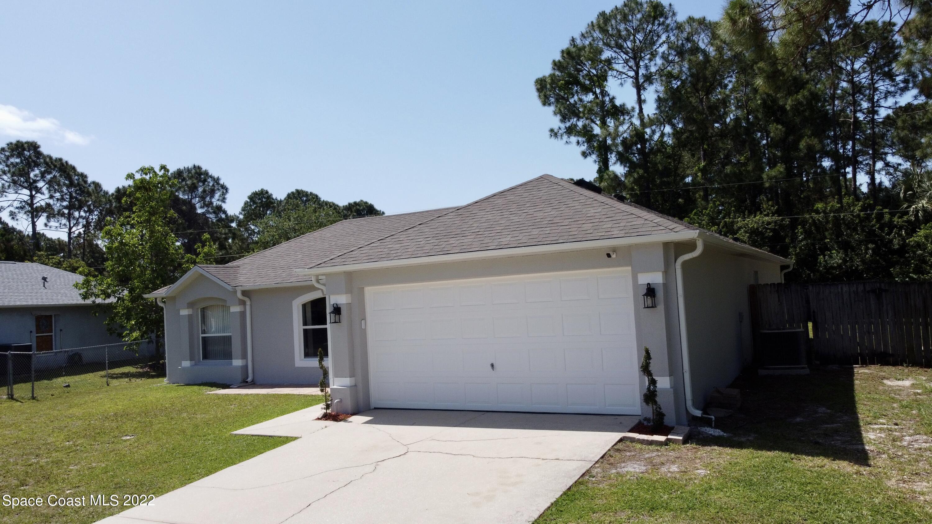 1290 Daton Road Southwest Palm Bay, FL 32908 - Photo 3 of 29 a front view of house with yard