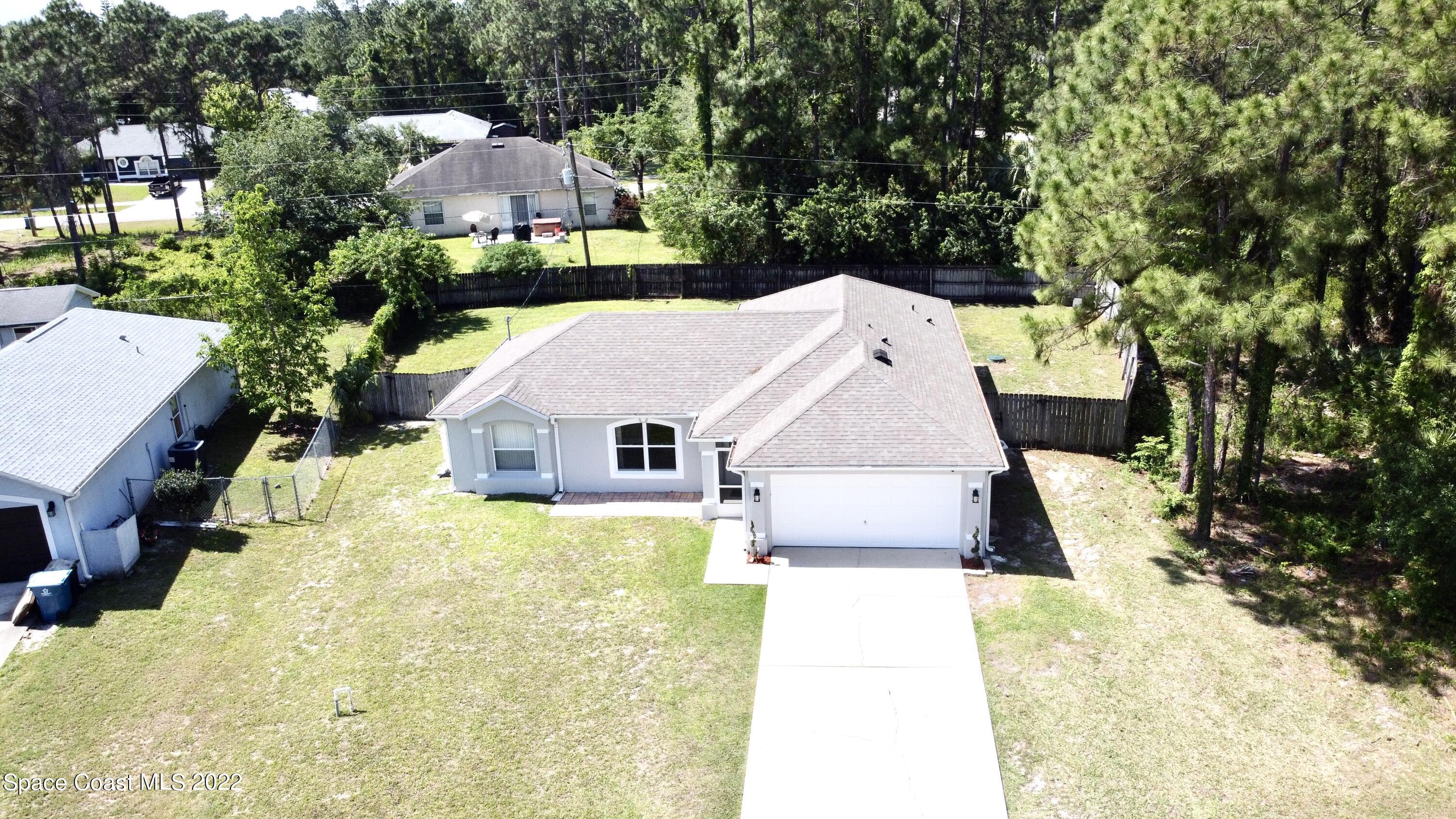1290 Daton Road Southwest Palm Bay, FL 32908 - Photo 6 of 29 an aerial view of a house with swimming pool and large trees