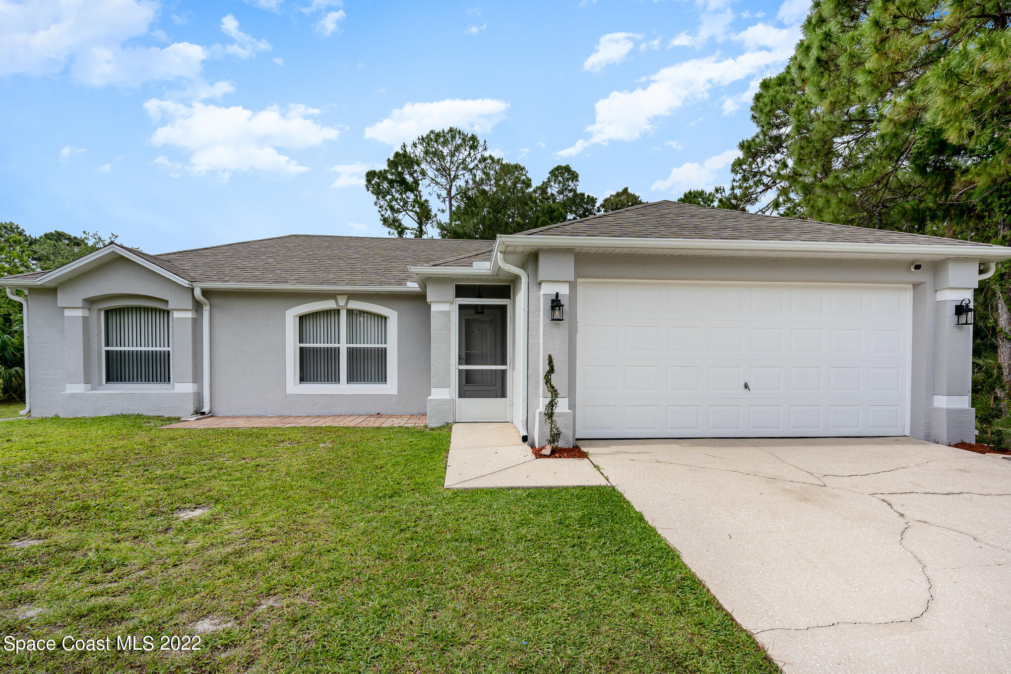 1290 Daton Road Southwest Palm Bay, FL 32908 - Photo 8 of 29 a front view of a house with a yard