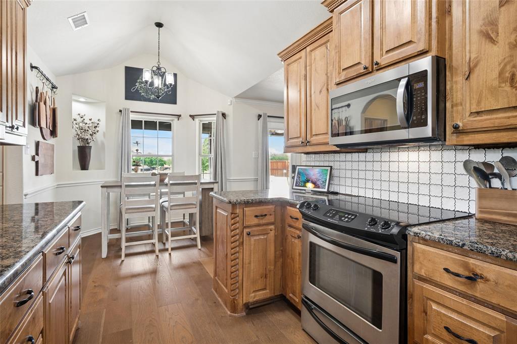199 Newfield Lane Springtown, TX 76082 - Photo 16 of 38 The kitchen features hardwood floors, granite countertops, and light wood cabinetry