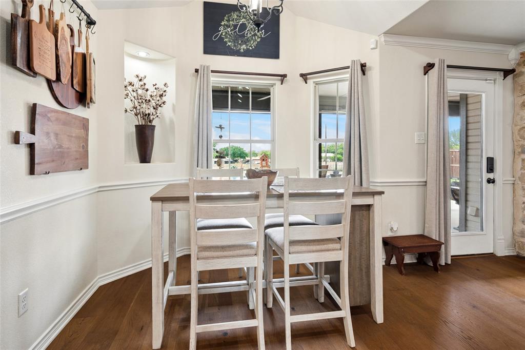 199 Newfield Lane Springtown, TX 76082 - Photo 17 of 38 The dining area features rich hardwood flooring, a vaulted ceiling, and two windows providing outdoor views
