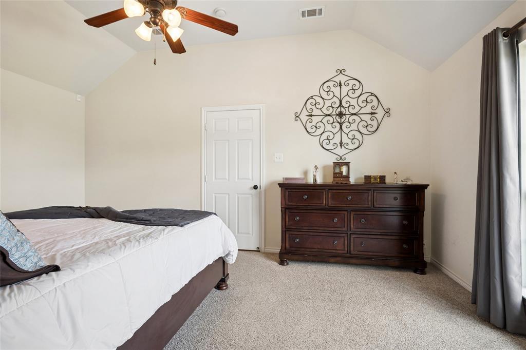 199 Newfield Lane Springtown, TX 76082 - Photo 19 of 38 This bedroom features vaulted ceilings, light-colored walls, and carpeting