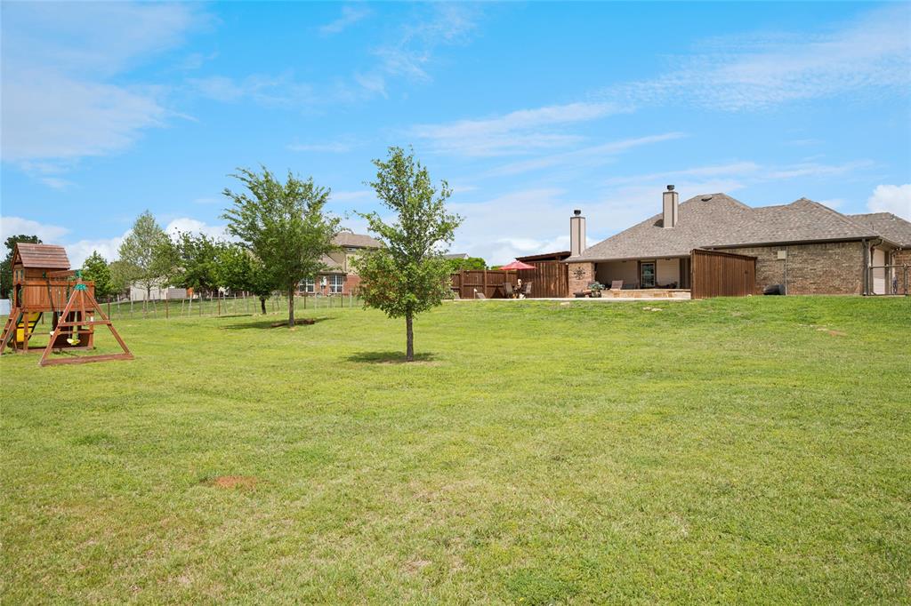 199 Newfield Lane Springtown, TX 76082 - Photo 27 of 38 This expansive property features extensive green lawn space, pool, putting green, playground, shop and a paved driveway