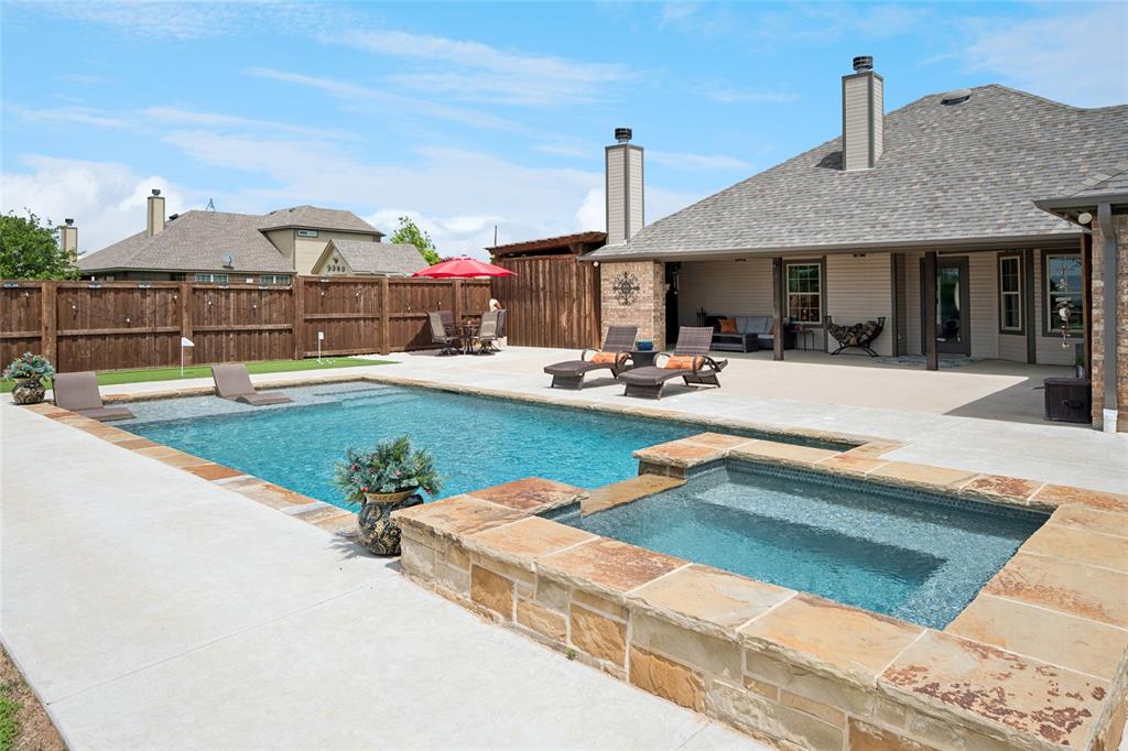 199 Newfield Lane Springtown, TX 76082 - Photo 28 of 38 The property features an expansive patio with a swimming pool and an integrated hot tub, surrounded by stone coping