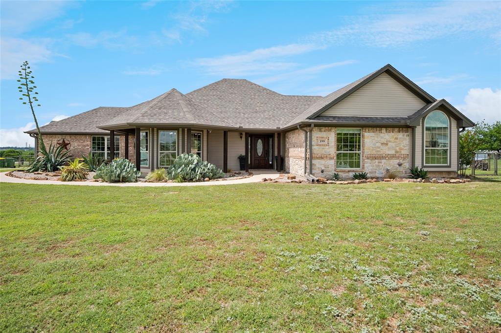 199 Newfield Lane Springtown, TX 76082 - Photo 3 of 38 An Oasis sitting on over 1 acre with T extensive green lawn space, pool, putting green, playground, shop and a paved driveway