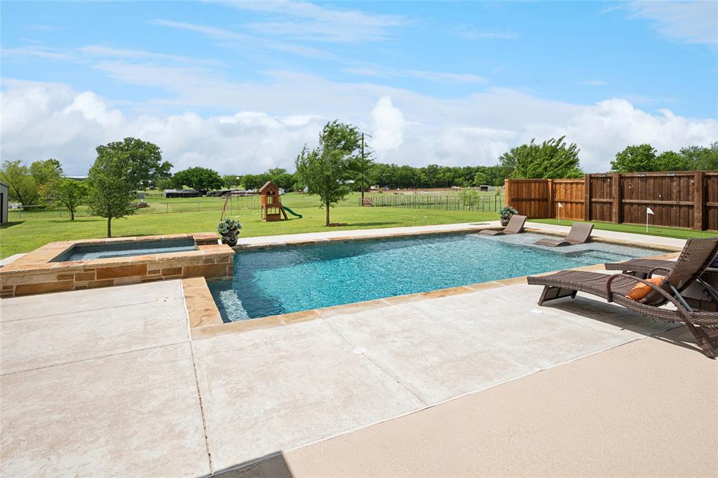 199 Newfield Lane Springtown, TX 76082 - Photo 31 of 38 This expansive property features extensive green lawn space, pool, putting green, playground, shop and a paved driveway.