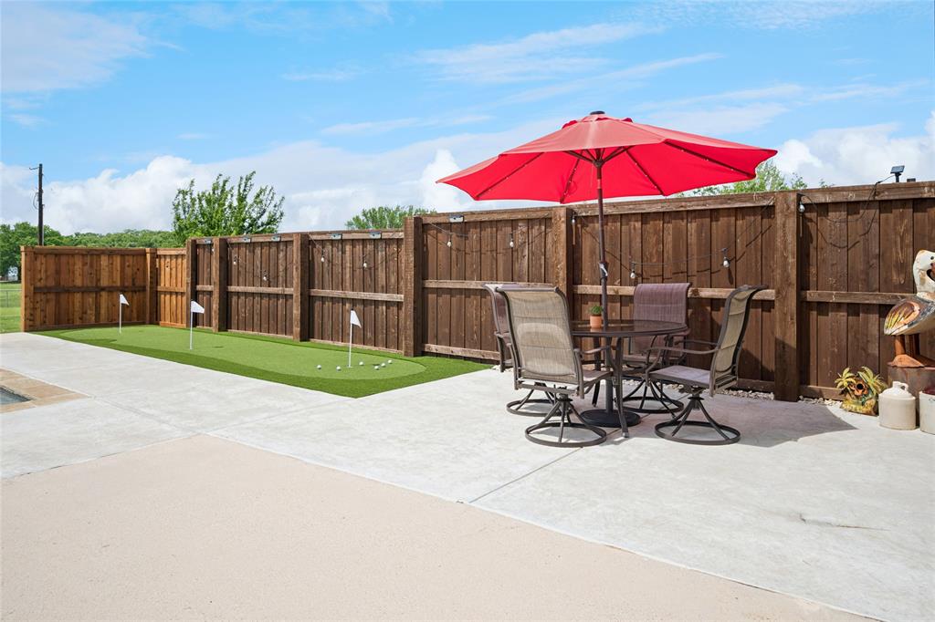 199 Newfield Lane Springtown, TX 76082 - Photo 32 of 38 This expansive property features extensive green lawn space, pool, putting green, playground, shop and a paved driveway.