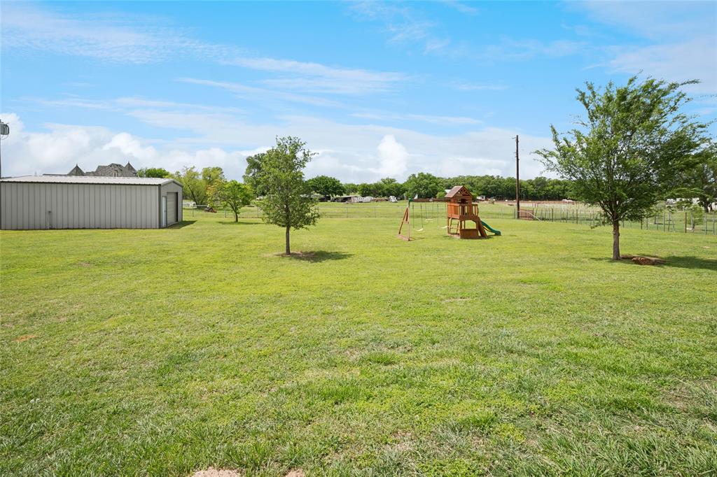 199 Newfield Lane Springtown, TX 76082 - Photo 33 of 38 This expansive property features extensive green lawn space, pool, putting green, playground, shop and a paved driveway