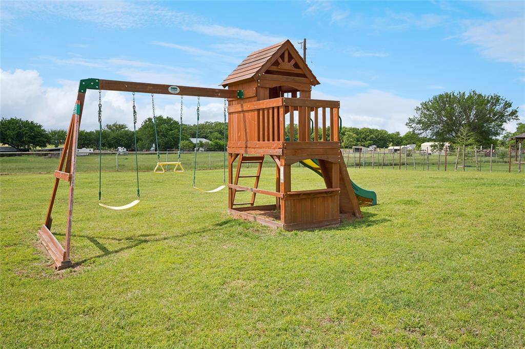 199 Newfield Lane Springtown, TX 76082 - Photo 35 of 38 This expansive property features extensive green lawn space, pool, putting green, playground, shop and a paved driveway