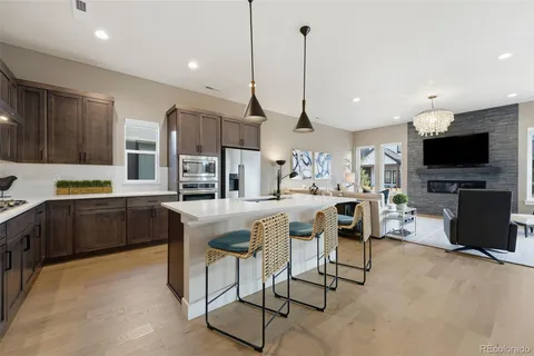 a kitchen with stainless steel appliances kitchen island granite countertop a sink and cabinets