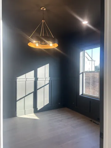 an empty room with windows and entrance