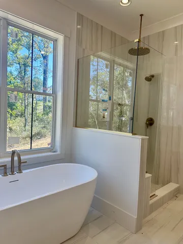 a bath tub sitting in a bathroom next to a window