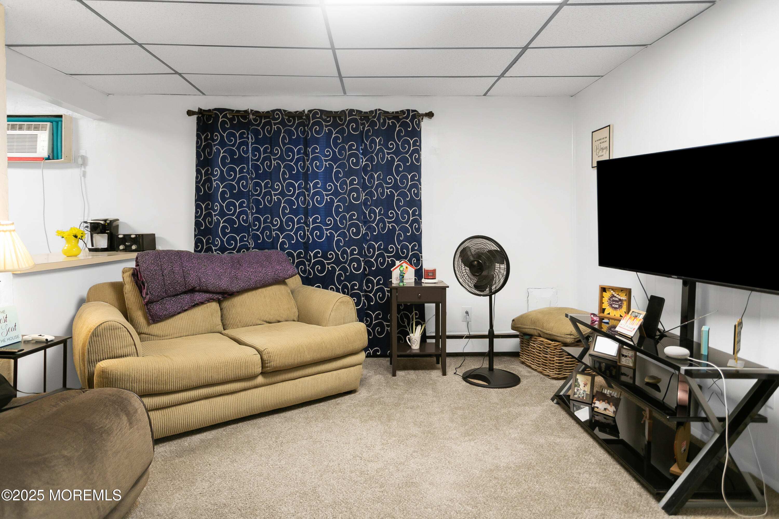 289 Port Monmouth Road North Middletown, NJ 07748 - Photo 12 of 37 a living room with furniture a flat screen tv and a fireplace
