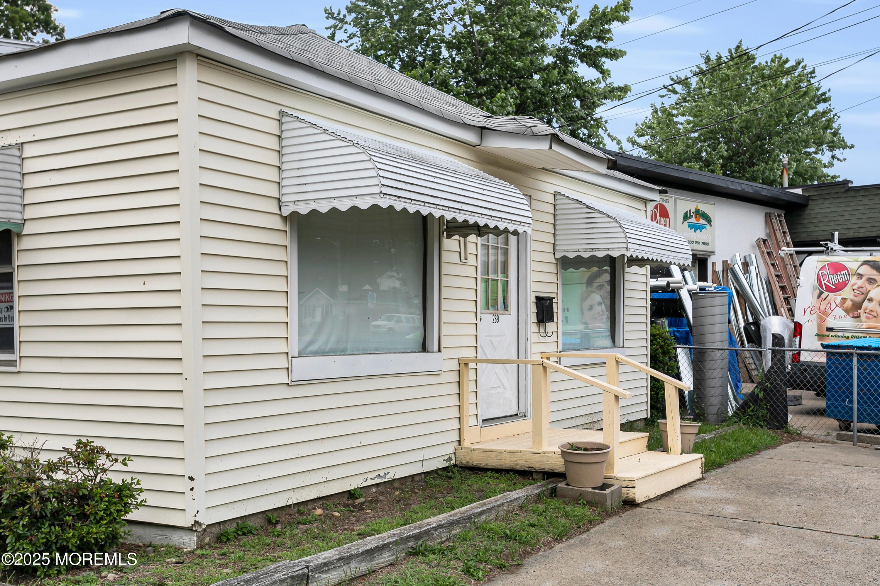 289 Port Monmouth Road North Middletown, NJ 07748 - Photo 3 of 37 a view of a white house with a small yard and a large tree
