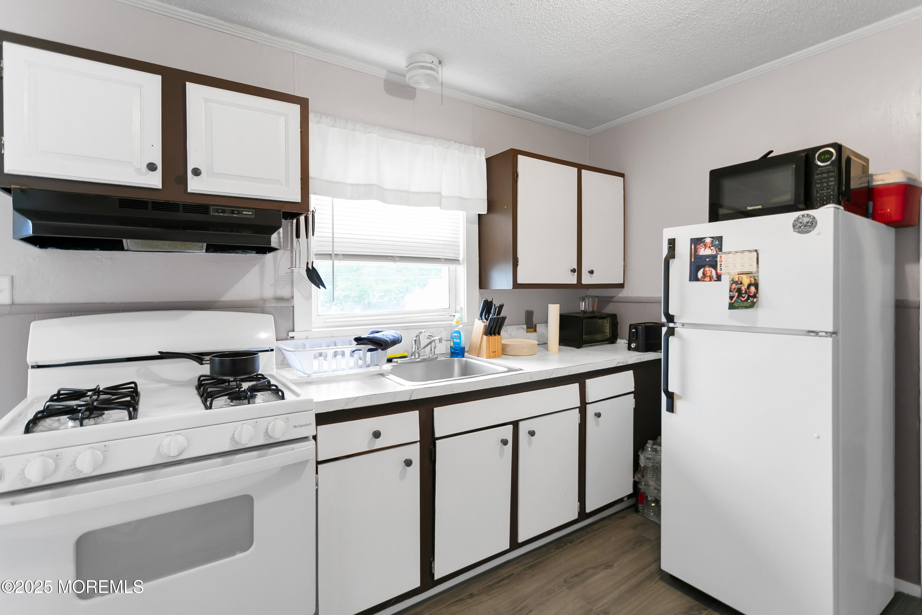 289 Port Monmouth Road North Middletown, NJ 07748 - Photo 33 of 37 a kitchen with appliances a sink and cabinets