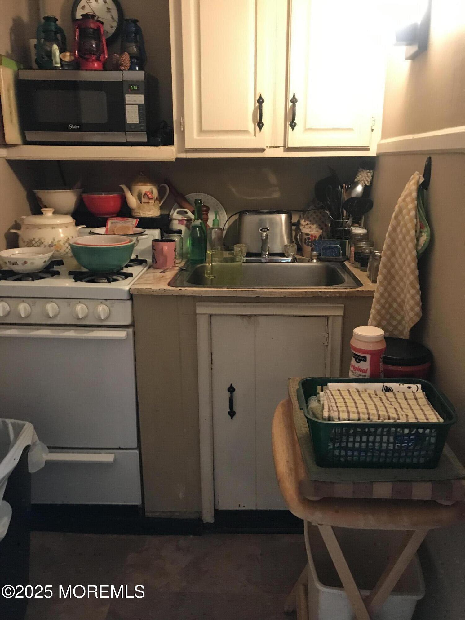 289 Port Monmouth Road North Middletown, NJ 07748 - Photo 35 of 37 a kitchen with a refrigerator and cabinets