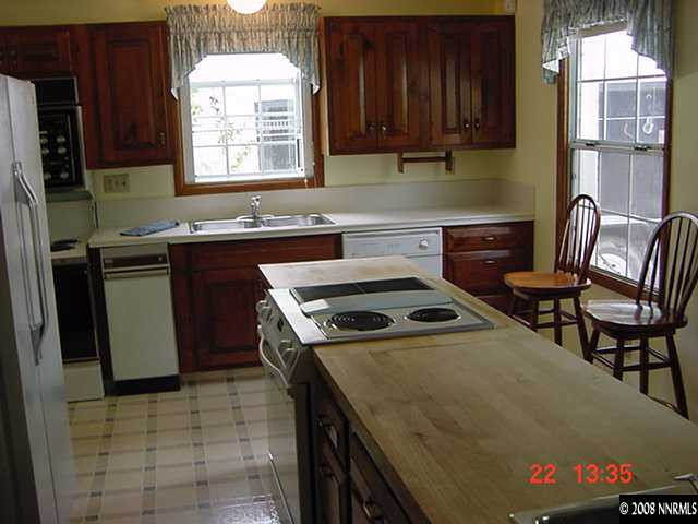 205 Urban Road Reno, NV 89509 - Photo 3 of 9 a kitchen with a stove a sink and a refrigerator