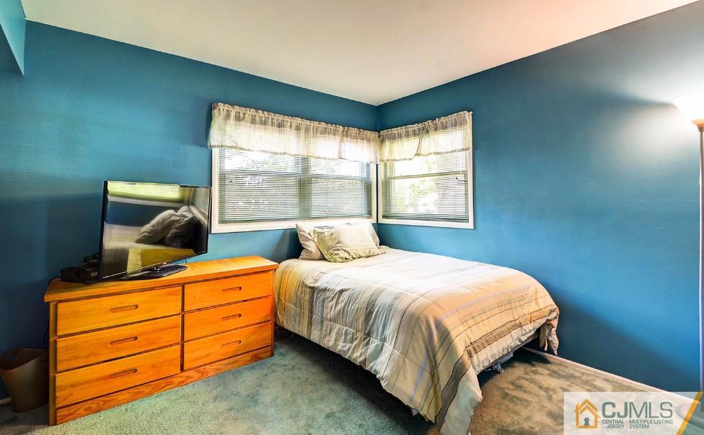 85 Kendall Road Kendall Park, NJ 08824 - Photo 14 of 25 a bedroom with a bed and window