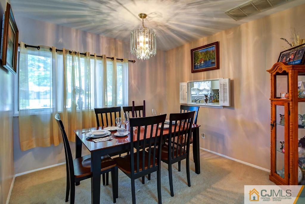 85 Kendall Road Kendall Park, NJ 08824 - Photo 6 of 25 a view of a dining room with furniture window and wooden floor