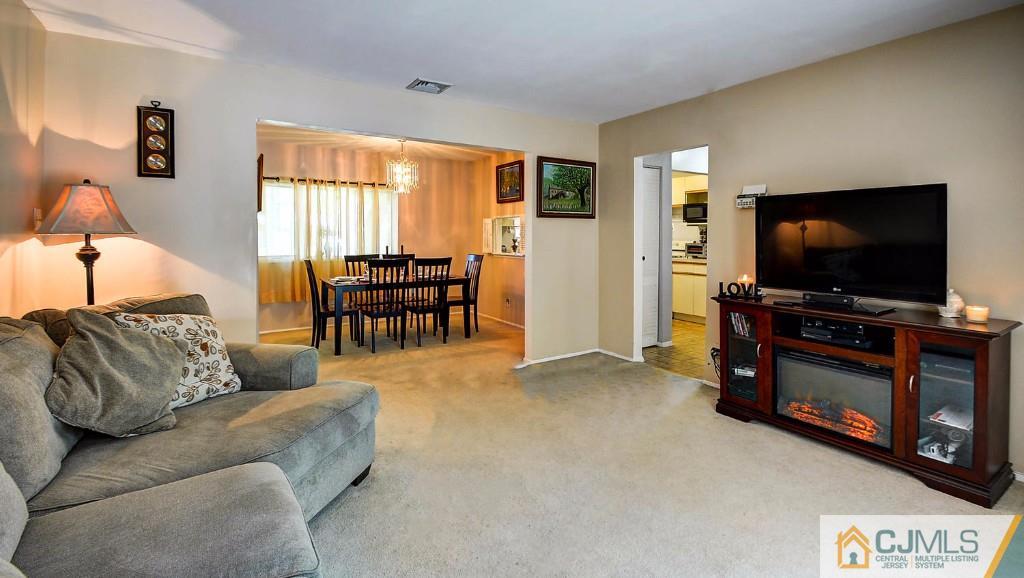 85 Kendall Road Kendall Park, NJ 08824 - Photo 8 of 25 a living room with furniture and a flat screen tv