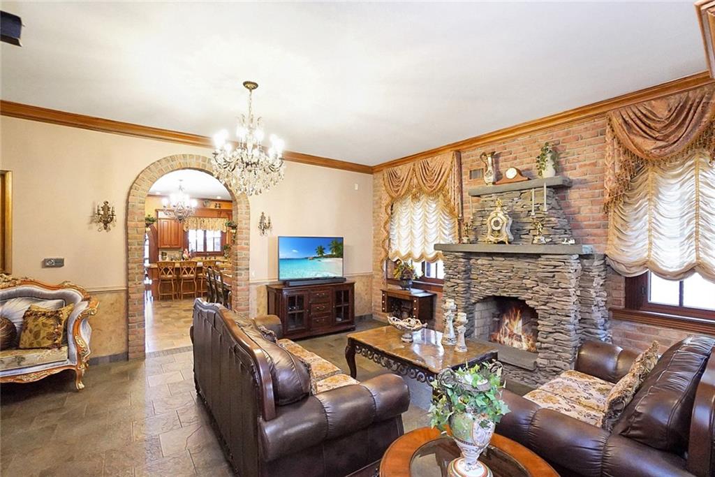 1406 73rd Street Brooklyn, NY 11228 - Photo 11 of 42 a living room with furniture a chandelier and a fireplace