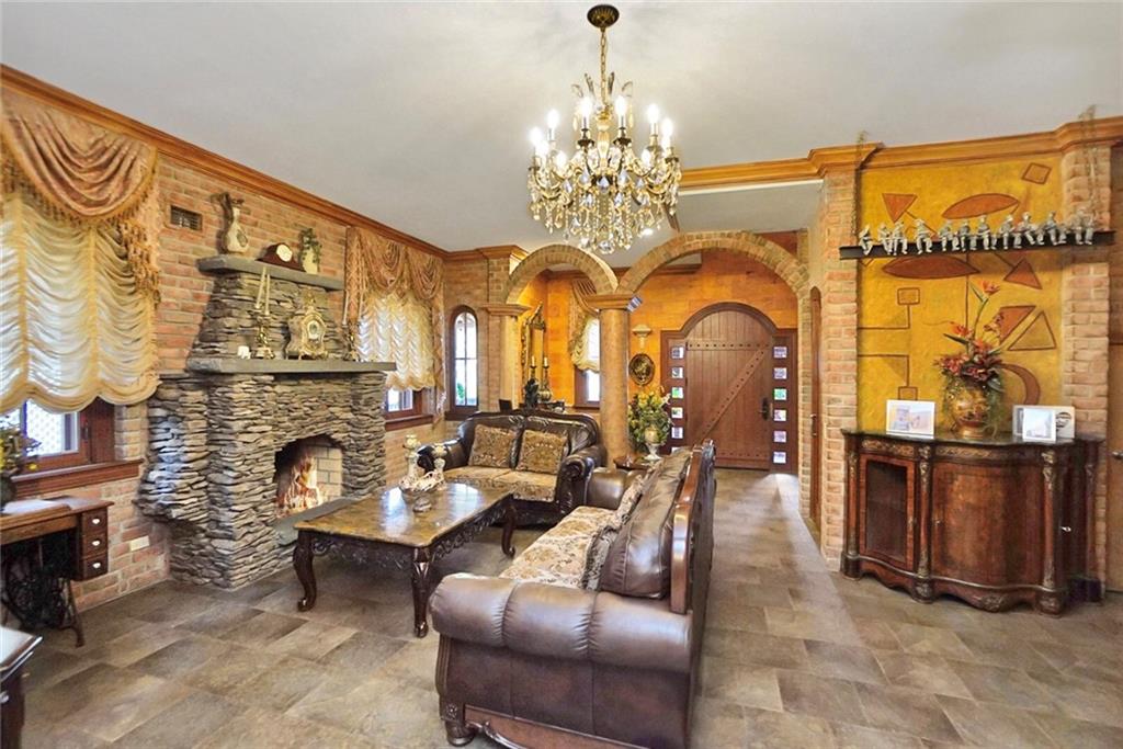 1406 73rd Street Brooklyn, NY 11228 - Photo 14 of 42 a living room with fireplace furniture and a chandelier