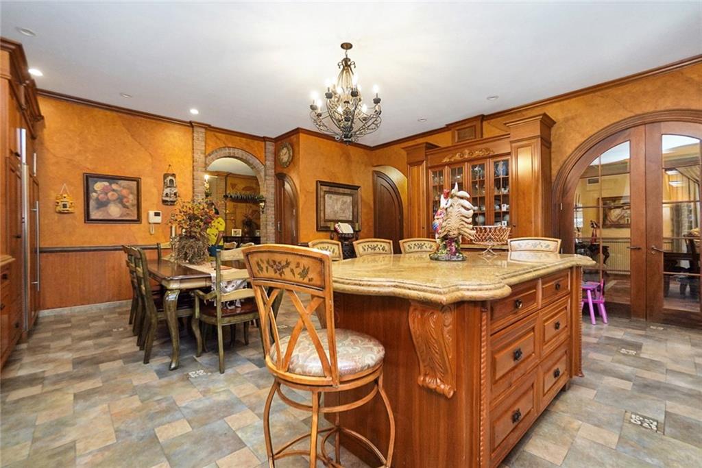 1406 73rd Street Brooklyn, NY 11228 - Photo 16 of 42 a kitchen with a dining table and chairs