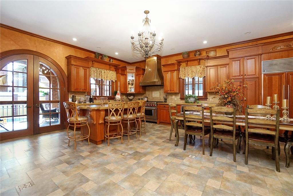 1406 73rd Street Brooklyn, NY 11228 - Photo 18 of 42 a view of a dining room with furniture and chandelier