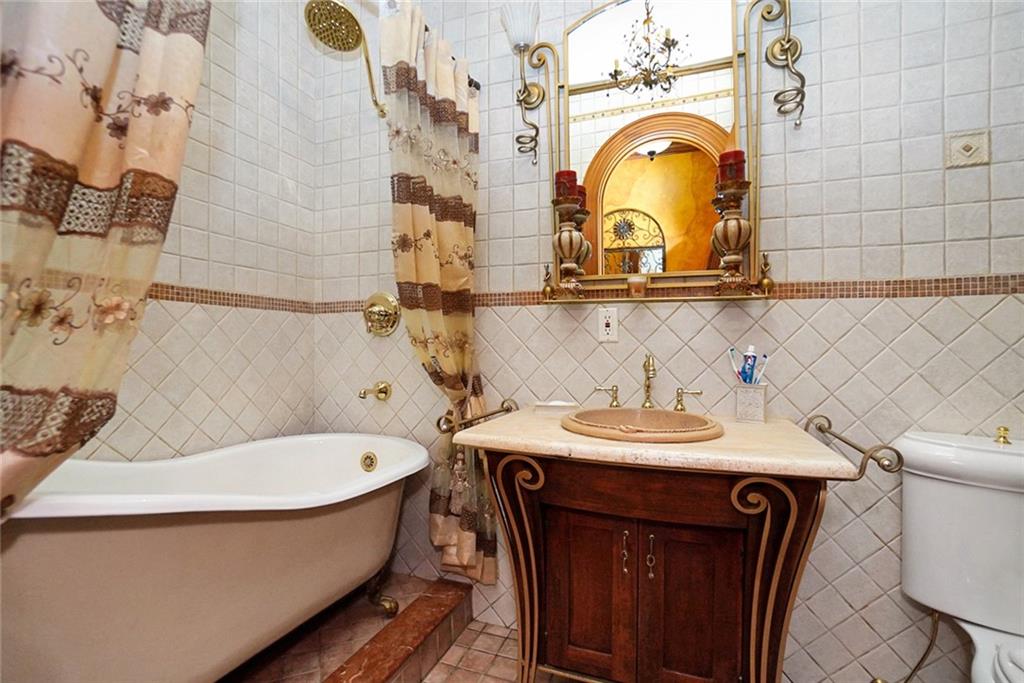 1406 73rd Street Brooklyn, NY 11228 - Photo 21 of 42 a bathroom with a sink and a mirror