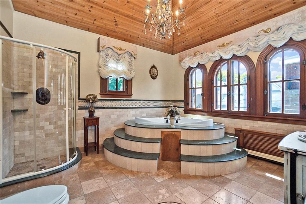 1406 73rd Street Brooklyn, NY 11228 - Photo 23 of 42 a spacious bathroom with a granite countertop sink a toilet a mirror and shower