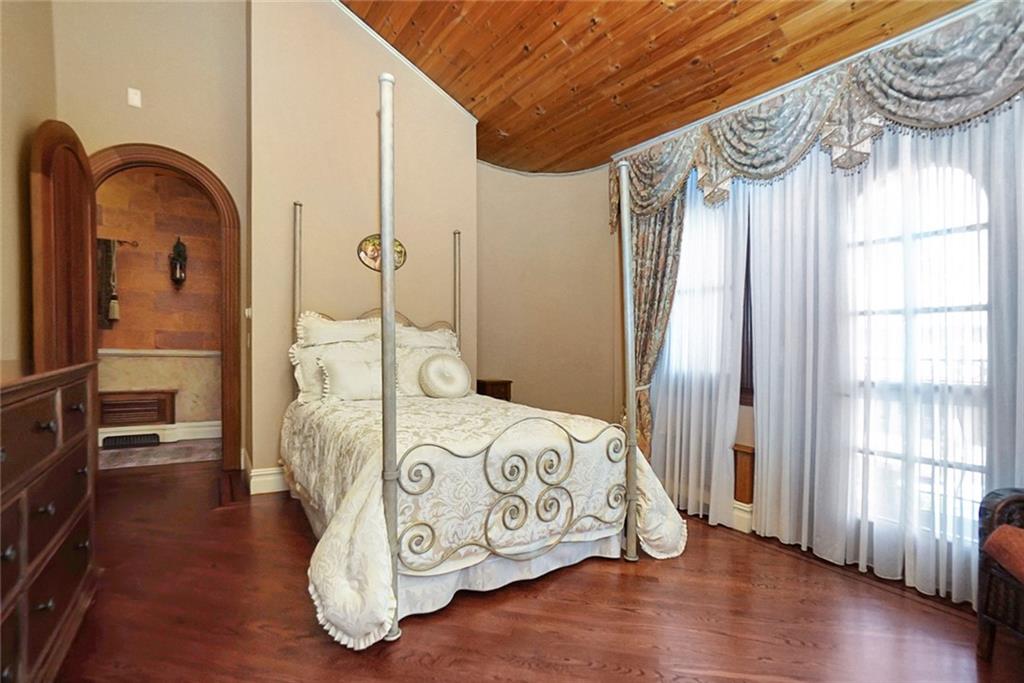 1406 73rd Street Brooklyn, NY 11228 - Photo 27 of 42 a bedroom with a bed and a mirror