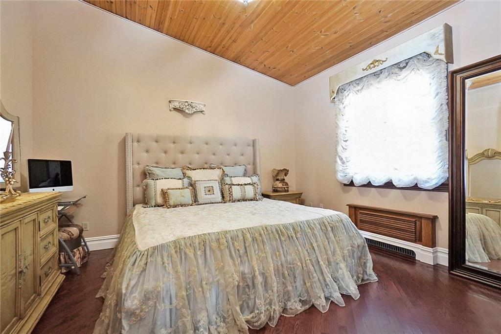 1406 73rd Street Brooklyn, NY 11228 - Photo 29 of 42 a bedroom with a bed and a flat tv screen on a dresser