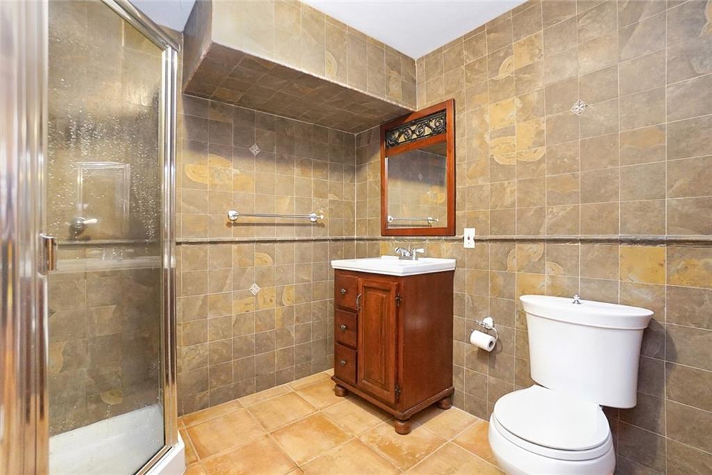 1406 73rd Street Brooklyn, NY 11228 - Photo 40 of 42 a bathroom with a toilet and a shower