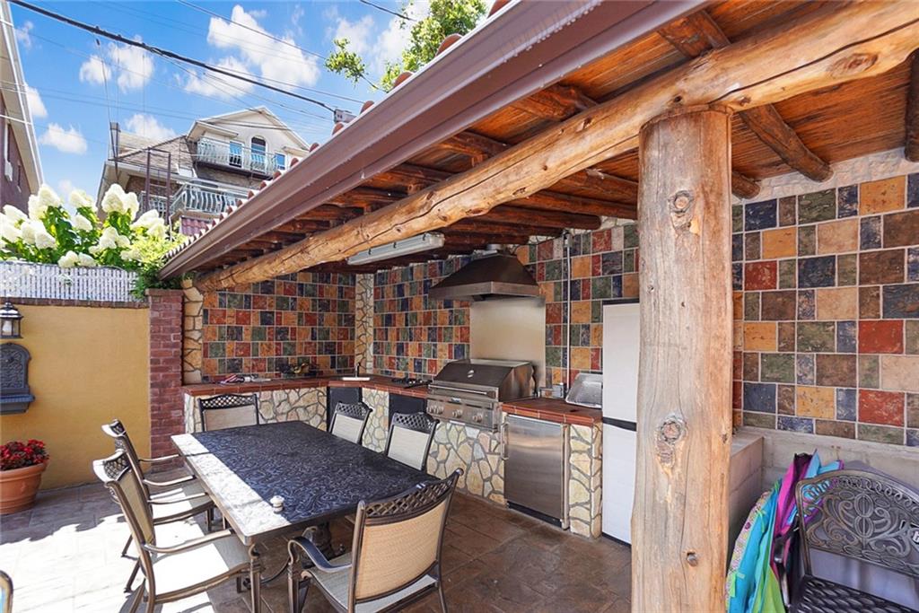 1406 73rd Street Brooklyn, NY 11228 - Photo 5 of 42 a view of a patio with a table and chairs and potted plants