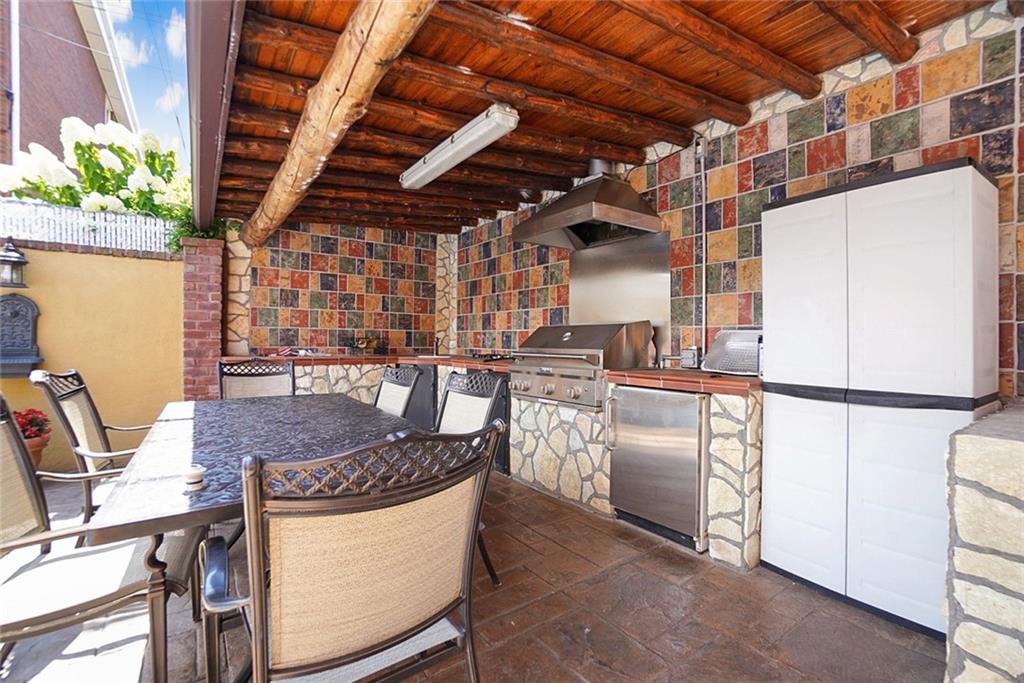 1406 73rd Street Brooklyn, NY 11228 - Photo 6 of 42 a kitchen with stainless steel appliances granite countertop a refrigerator a sink and a stove