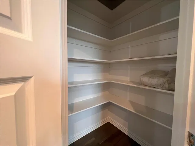 a view of walk in closet with empty racks