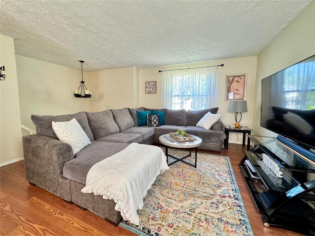 142 Partridge Run Road Gibsonia, PA 15044 - Photo 12 of 32 a living room with furniture a rug and a flat screen tv