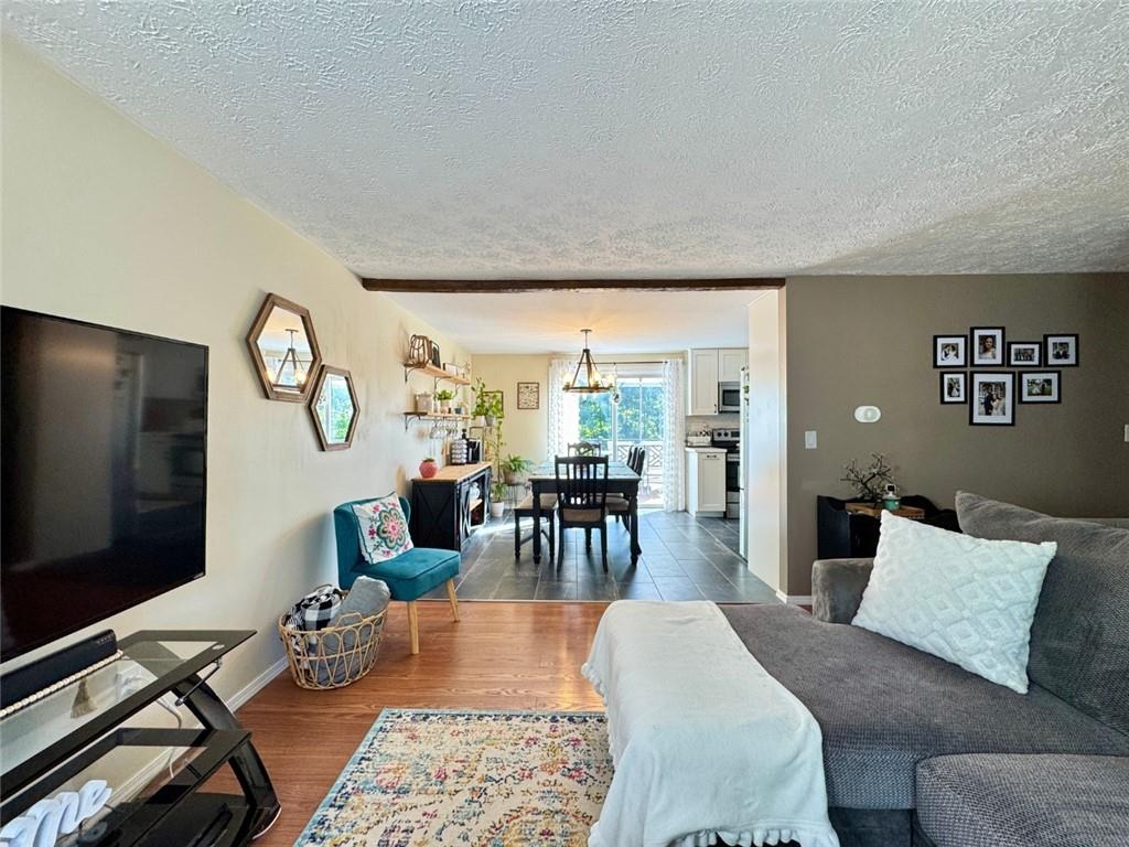 142 Partridge Run Road Gibsonia, PA 15044 - Photo 13 of 32 a living room with furniture a rug and a flat screen tv