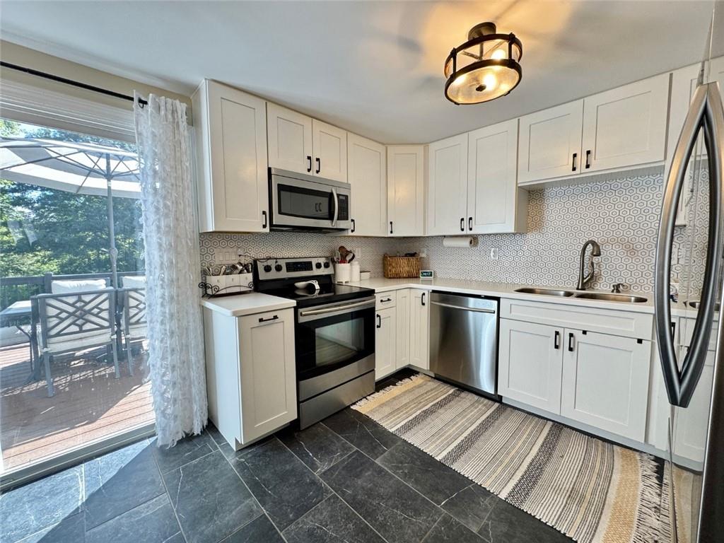 142 Partridge Run Road Gibsonia, PA 15044 - Photo 16 of 32 a kitchen with cabinets stainless steel appliances a sink and a stove