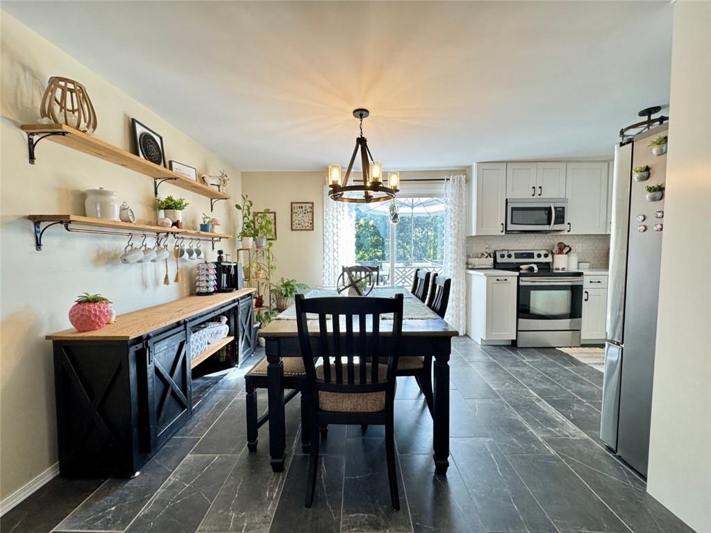 142 Partridge Run Road Gibsonia, PA 15044 - Photo 17 of 32 a view of a dining room with furniture wooden floor and chandelier